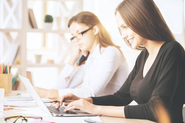 istock Gorgeous females using laptop at workplace 865821928