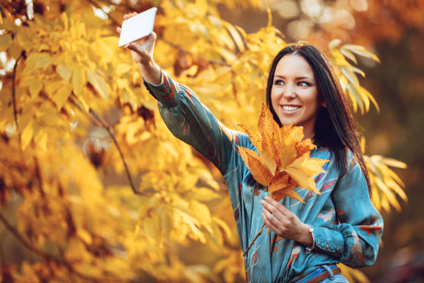 istock Selfie In Autumn Park 865824696