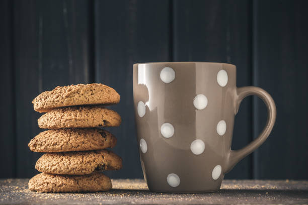istock Stack of oat cookies over dark wood 865828410