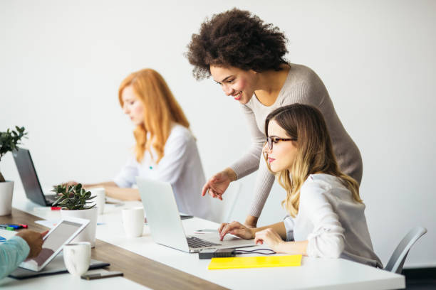 istock Young business women working on a laptop in office 865828536