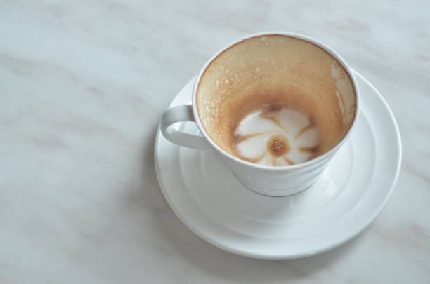 istock Cup cappuccino is Finished drink(with a flower pattern on the surface) on White marble table. 865832596