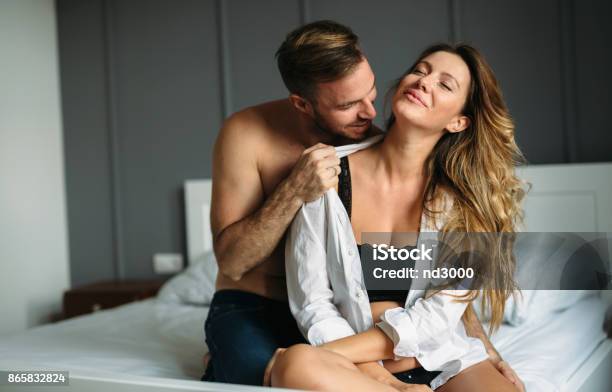 Attractive Couple Sharing Intimate Moments In Bedroom Stock Photo - Download Image Now