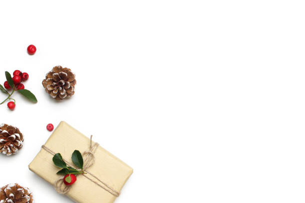 istock Christmas festive styled stock image composition. Handmade gift box, red berries and pine cones isolated on white wooden background. Flat lay, top view 865833358
