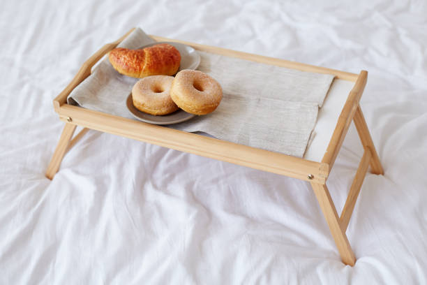 istock Breakfast in bed with croissant and donuts on a tray 865833514