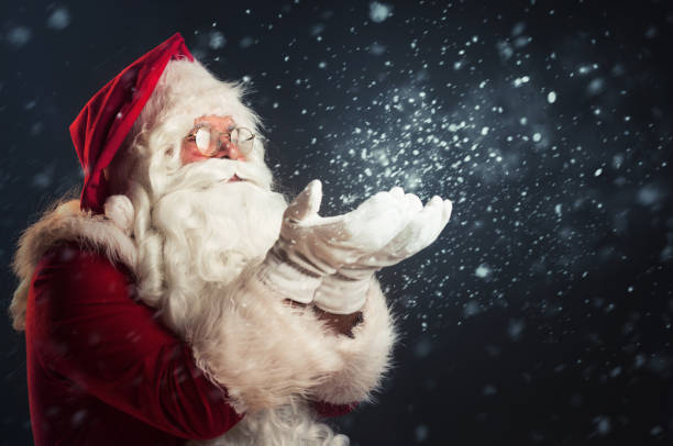 istock Santa Claus blowing snow of his hands 865835732