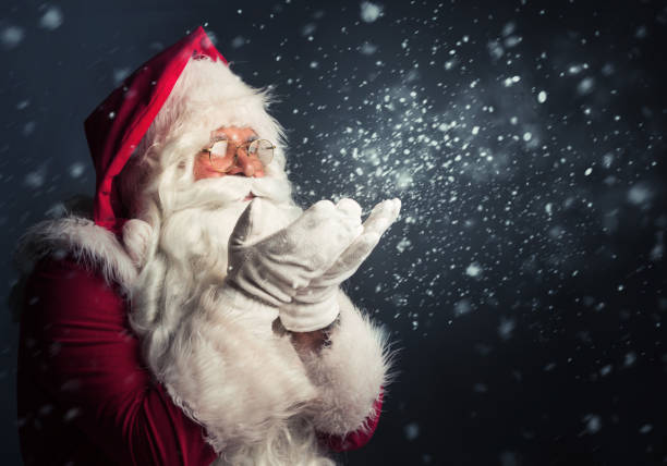 istock Santa Claus blowing snow of his hands 865835734