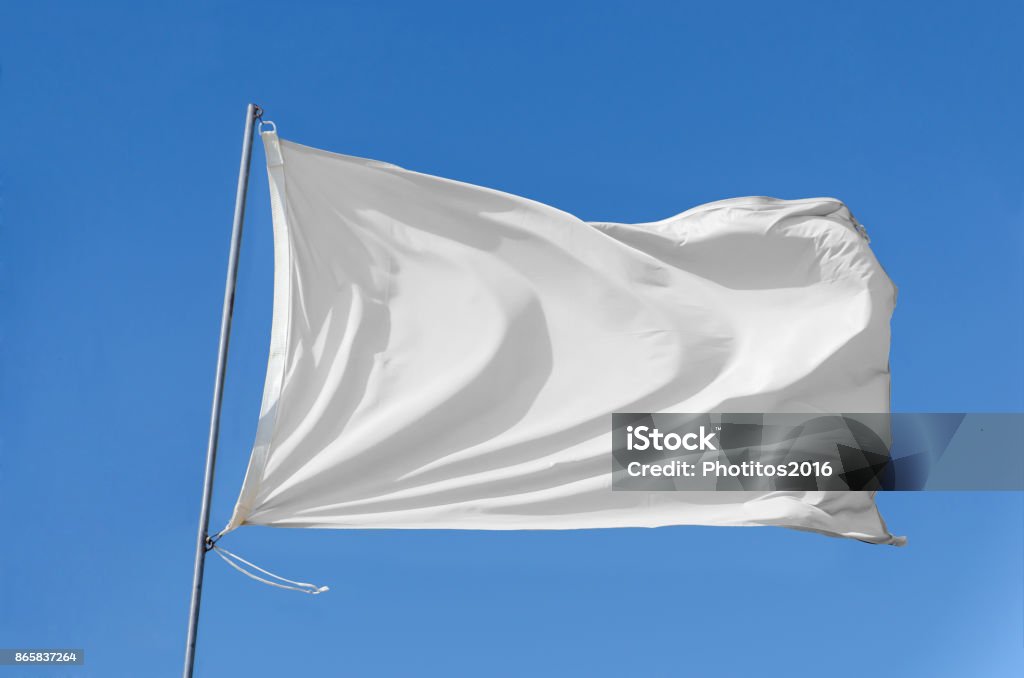 flag waving on the sky White flag attached to a flagpole waving on the sky White Flag Stock Photo