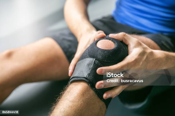 Sports Injuries Bandaged Knee Stock Photo - Download Image Now - Physical Injury, Sport, Knee