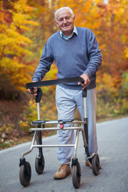 istock Senior handicapped man with a walker in a park 865847676