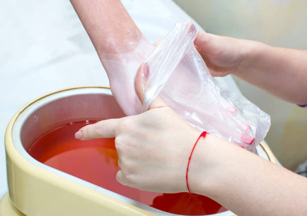 istock Process paraffin treatment of female hands 865848028