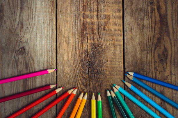 istock Colored pencils in gradient order located below on wooden table. School concept. Copy space 865848350