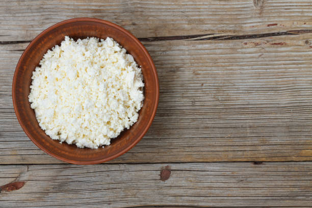 istock Fresh cottage cheese in a bowl on a wooden table 865848966