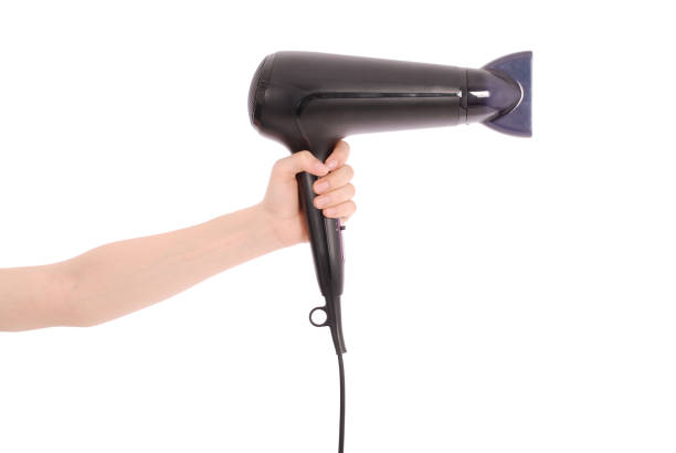 asciugacapelli in mano alla donna. - hair dryer single object plastic black foto e immagini stock