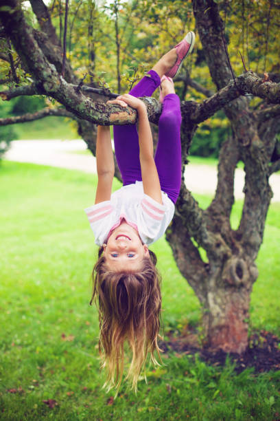 girl playing on a tree