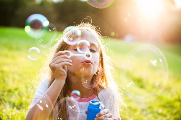 istock Girl Blowing Bubbles 865854250