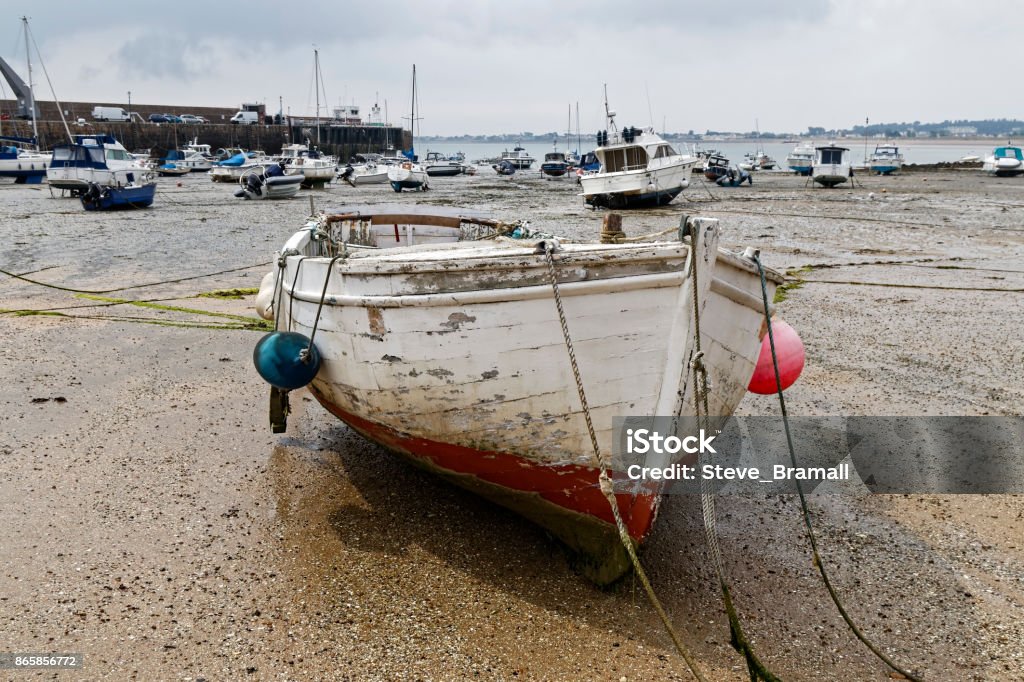 Gorey beach at low tide Boats on Gorey beach at low tide on a grey, overcast, day. Bay of Water Stock Photo