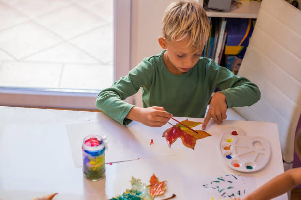 istock Blond hair boy painting 865863882