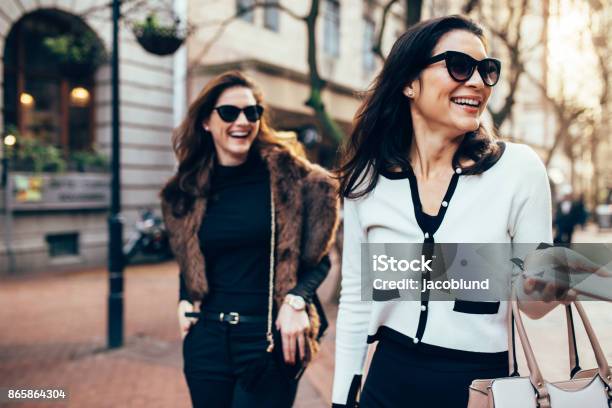 Two Women On City Street Having Fun Stock Photo - Download Image Now - Luxury, Shopping, Lifestyles