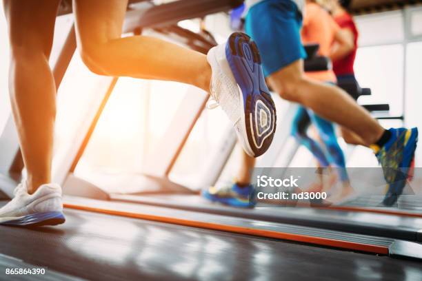 Picture Of People Running On Treadmill In Gym Stock Photo - Download Image Now - Leg, Treadmill, Adult