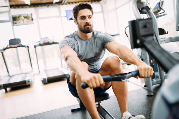 istock Young handsome man doing exercises in gym 865864524