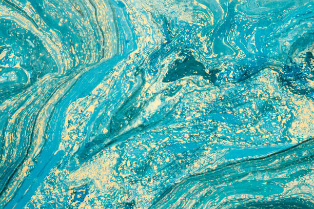 istock Modern artwork with abstract marble painting.   Mixed blue and yellow paints. Unusual handmade background for poster, card, invitation. Acrylic paints on water surface. Horizontal. 865864882