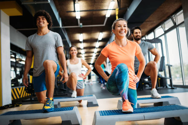 istock Group of young people doing exercises in gym 865867464
