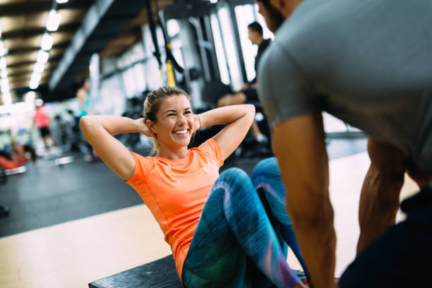 istock Young beautiful woman doing exercises with personal trainer 865867948