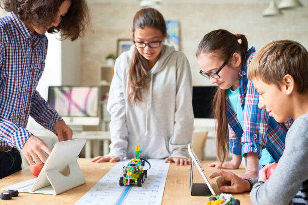 istock School friends holding experiment with toy vehicle 865868334