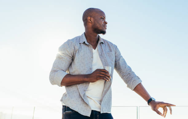 istock Man holding a glass of wine 865868444