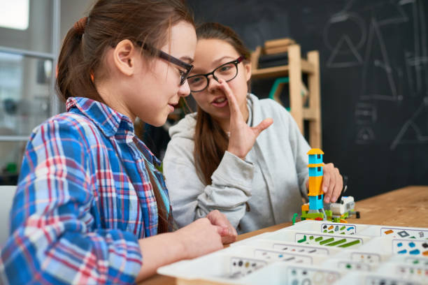 istock Little gossip girls at robotics class 865870980