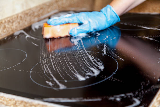 istock Washing electric stove with soft sponge 865872152