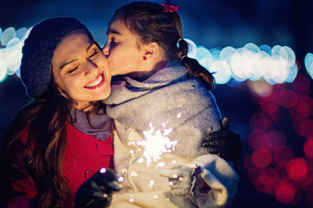 istock Daughter is kissing her mom at Christmas 865875650