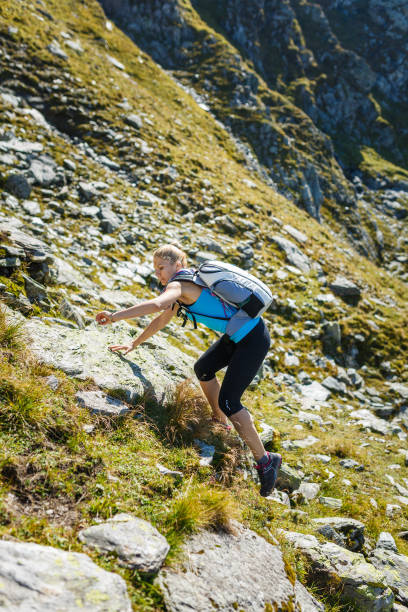 istock Woman backpacker hiking on a trail 865880368