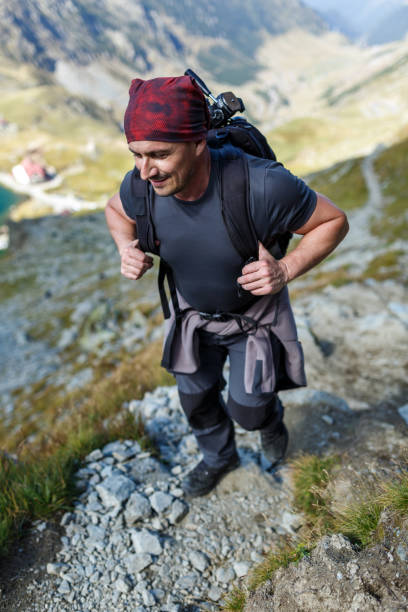 istock Man backpacker hiking on a trail 865880750