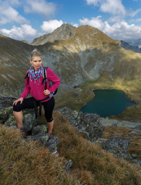 istock Woman backpacker hiking on a trail 865880924