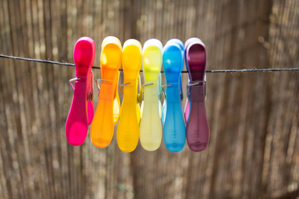 Different colors clothespins hanged on the rope