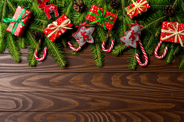 istock Christmas background with colorful gift boxes and decorations over wooden table 865881272