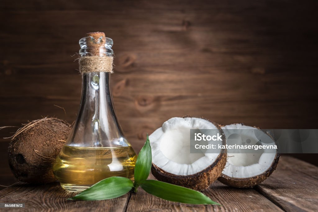 Spa still life with coconut and massage oil Coconut Oil Stock Photo