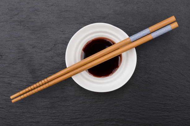 istock Sushi chopsticks and soy sauce on stone plate 865887778