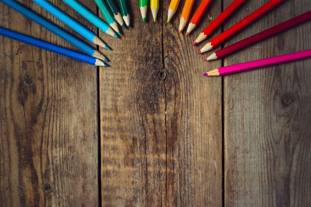 istock Colored pencils in gradient order located folded on wooden table. School concept. Copy space 865888586
