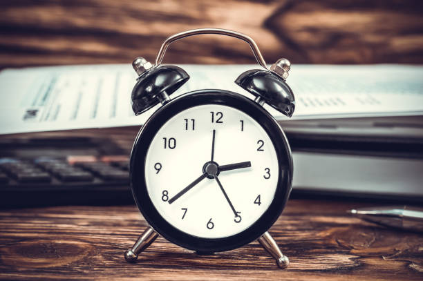 istock Alarm clock on the office workplace. Business concept. Toned image. 865888722