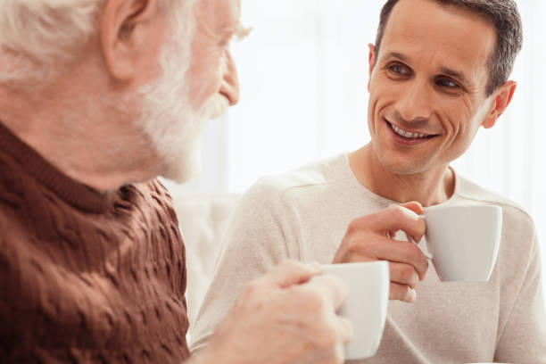 istock Delighted young man talking with his grandpa 865888890
