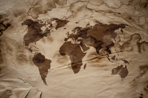 istock World Map on aged damaged paper 865889416