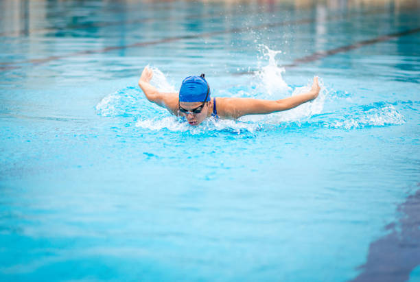 istock Professional female swimmer swimming butterfly stroke 865890158