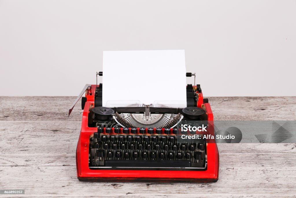 White page in typewriter maschine Photo vintage red typewriter on the table with paper Typewriter Stock Photo