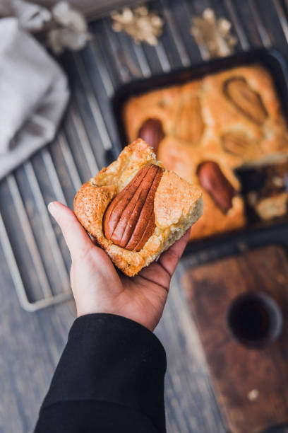 istock Woman's hand holding piece of pear cake 865890674