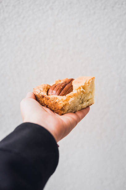 Woman's hand holding piece of pear cake