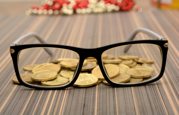 istock Eye Glass with gold coins - Analysis concept 865893856