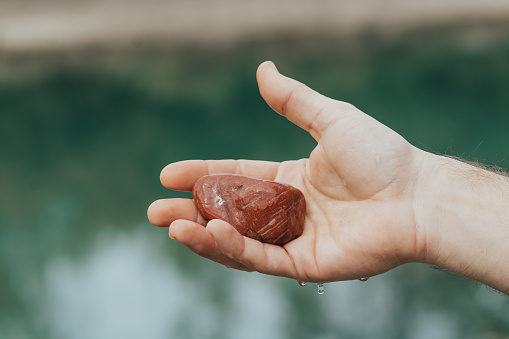 Holding a stone from spring water