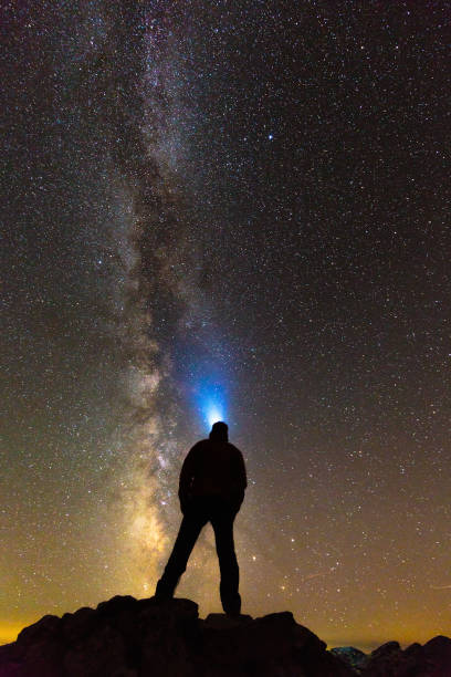istock Silhouette of a man looking at stars 865899404